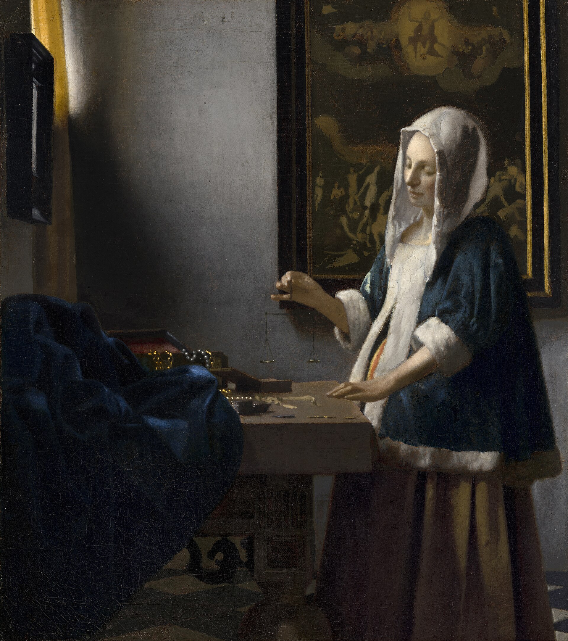 Johannes Vermeer, Woman Holding a Balance, c. 1664. A woman in a blue jacket stands at a table holding an empty balance, light from a window falling on her hand; behind her hangs a painting of the Last Judgement. Pearls and gold coins lie on the table.
